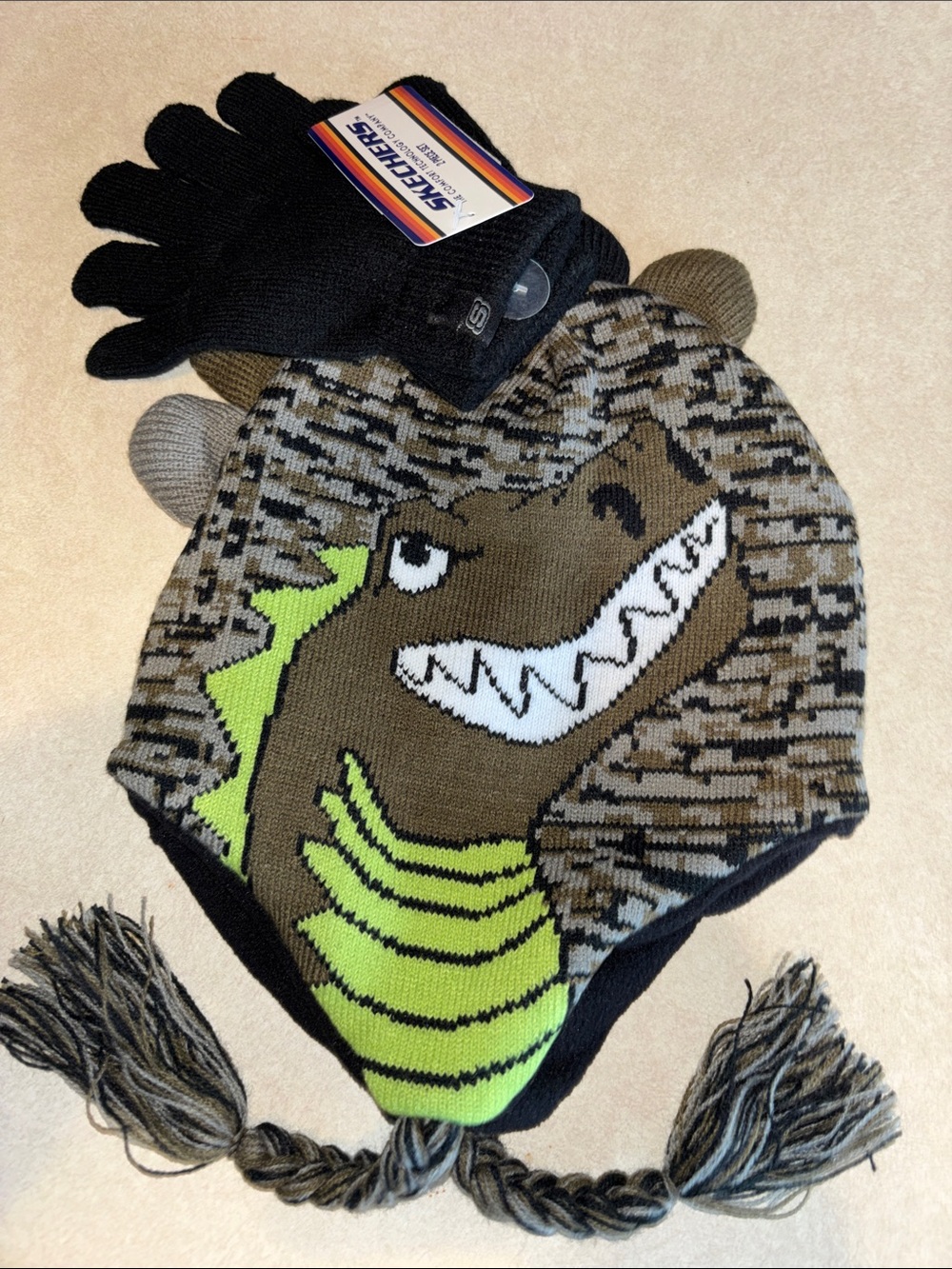 Skechers Kids Dino Earflap Beanie Hat in Brown, Green & Black with Black Gloves